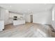 Open-concept living space with kitchen, stainless appliances, island and ample natural light at 6615 N Nepal St, Aurora, CO 80019
