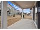 View of the backyard and neighboring home from the covered back patio at 6615 N Nepal St, Aurora, CO 80019