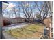 Landscaped backyard with a brick retaining wall at 1130 Oak Pl, Thornton, CO 80229