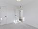 Simple bedroom with gray carpet and an open doorway at 1130 Oak Pl, Thornton, CO 80229