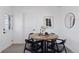 Small dining area with round wooden table and four black chairs at 1130 Oak Pl, Thornton, CO 80229