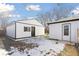 Detached garage with new paint and a black garage door at 1130 Oak Pl, Thornton, CO 80229