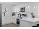 Modern white kitchen with stainless steel appliances and marble backsplash at 1130 Oak Pl, Thornton, CO 80229