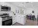 Open concept kitchen with island and adjacent dining area at 1130 Oak Pl, Thornton, CO 80229