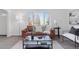 Living room features a brown leather couch and a glass-top coffee table at 1130 Oak Pl, Thornton, CO 80229