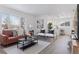 Open concept living room and kitchen with light hardwood floors at 1130 Oak Pl, Thornton, CO 80229