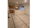 Small basement kitchen with wood cabinets and tile flooring at 19877 E 40Th Ave, Denver, CO 80249