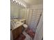 Clean bathroom with shower/tub combo, vanity, and updated flooring at 19877 E 40Th Ave, Denver, CO 80249