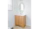 Bathroom with wood vanity and an oval mirror at 19877 E 40Th Ave, Denver, CO 80249