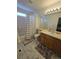 Bathroom with a shower/tub combo, wood vanity, and marble-look flooring at 19877 E 40Th Ave, Denver, CO 80249