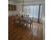 Dining room with hardwood floors, built-in hutch, and table with chairs at 19877 E 40Th Ave, Denver, CO 80249