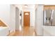 Hardwood floor hallway with an interior door and kitchen access at 19877 E 40Th Ave, Denver, CO 80249