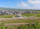 Aerial view of a neighborhood with walking paths, a gazebo, green spaces, and mountain views in the background at 11103 Cloud Shadow St, Littleton, CO 80125