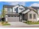 Charming two-story home features stone accents, gray siding, and a well-manicured lawn, creating inviting curb appeal at 11103 Cloud Shadow St, Littleton, CO 80125