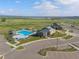 Aerial view showcasing the community pool, playground, clubhouse, and surrounding green spaces on a sunny day at 11103 Cloud Shadow St, Littleton, CO 80125