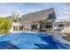 Wide backyard shot featuring an in-ground pool and covered stone patio at 3577 S Hillcrest Dr, Denver, CO 80237