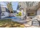 Lovely backyard offers a cozy patio with a seating area and a covered pool for year-round enjoyment at 3577 S Hillcrest Dr, Denver, CO 80237