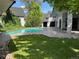A lush backyard features a sparkling pool, patio space, and green lawn perfect for entertaining at 3577 S Hillcrest Dr, Denver, CO 80237