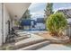Beautiful backyard with a pool covered for the off-season, lounge furniture, and mature trees at 3577 S Hillcrest Dr, Denver, CO 80237