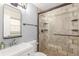 Bathroom featuring a vanity sink, updated fixtures, a large mirror, and a modern tiled shower at 3577 S Hillcrest Dr, Denver, CO 80237