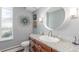 Stylish bathroom with granite countertop, mosaic backsplash, wood vanity and silver accents at 3577 S Hillcrest Dr, Denver, CO 80237