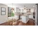 Bright kitchen with white cabinets, modern lighting, stainless steel appliances, and an adjacent dining area at 3577 S Hillcrest Dr, Denver, CO 80237
