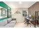 Comfortable living room with stylish decor, natural light, a gray couch, and a modern desk area at 3577 S Hillcrest Dr, Denver, CO 80237