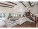 Open-concept living room featuring high ceilings, wood beams, and sliding glass doors at 3577 S Hillcrest Dr, Denver, CO 80237