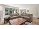 Bright and spacious living room with large windows that let in natural light and a large sectional sofa at 3577 S Hillcrest Dr, Denver, CO 80237