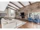 Cozy living room with a stone fireplace, wood beam ceilings, and comfortable seating at 3577 S Hillcrest Dr, Denver, CO 80237