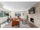 Inviting living room with stone fireplace, wood floors, and ample natural light at 3577 S Hillcrest Dr, Denver, CO 80237