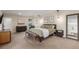 Spacious main bedroom featuring warm lighting, a seating area, and a large bed with comfortable decor at 3577 S Hillcrest Dr, Denver, CO 80237