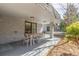 Inviting outdoor patio features a dining table, stylish chairs, and seamless access to the backyard at 3577 S Hillcrest Dr, Denver, CO 80237