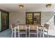 A covered outdoor patio features a modern dining set with seating for six and recessed lighting at 3577 S Hillcrest Dr, Denver, CO 80237