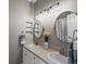 Bright bathroom with dual sinks, decorative mirrors, and modern lighting fixtures at 10531 Lieter Pl, Lone Tree, CO 80124