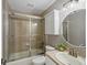 Full bathroom featuring glass shower door, tiled walls and floors, and a vanity with a modern sink at 10531 Lieter Pl, Lone Tree, CO 80124