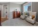 Bedroom featuring plush carpeting, a wooden dresser, and cozy seating by a window at 10531 Lieter Pl, Lone Tree, CO 80124
