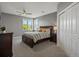 Spacious bedroom featuring large windows, a ceiling fan, and plenty of closet space at 10531 Lieter Pl, Lone Tree, CO 80124