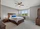 Sunlit bedroom with a large window, wood furniture, and soft, neutral décor at 10531 Lieter Pl, Lone Tree, CO 80124