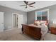 Cozy bedroom with a sleigh bed, neutral decor, a ceiling fan and ensuite bathroom at 10531 Lieter Pl, Lone Tree, CO 80124