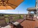 Relaxing deck area with outdoor seating, umbrella and mountain views at 10531 Lieter Pl, Lone Tree, CO 80124