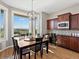 Bright dining room with wood floors, large windows with great views, and stylish light fixture at 10531 Lieter Pl, Lone Tree, CO 80124