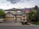 Beautiful home with a three-car garage and stone accents at sunset at 10531 Lieter Pl, Lone Tree, CO 80124