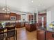 Spacious kitchen featuring a large island, stainless steel appliances, granite countertops, and wood floors at 10531 Lieter Pl, Lone Tree, CO 80124