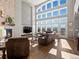 Bright living room with soaring windows and a fireplace at 10531 Lieter Pl, Lone Tree, CO 80124