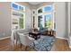 Sunlit living room with plush seating and large windows at 10531 Lieter Pl, Lone Tree, CO 80124