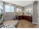 Main bathroom with glass shower, soaking tub, double vanity, and decorative planters at 10531 Lieter Pl, Lone Tree, CO 80124