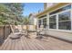 Back Deck features cozy outdoor seating area with a stone fire pit, perfect for relaxing and entertaining at 5604 S Lisbon Way, Centennial, CO 80015