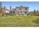 Spacious backyard with lush lawn, large patio, deck, and privacy fence, perfect for outdoor enjoyment at 5604 S Lisbon Way, Centennial, CO 80015