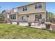 Spacious backyard with lush lawn, large patio, deck, and privacy fence, perfect for outdoor enjoyment at 5604 S Lisbon Way, Centennial, CO 80015